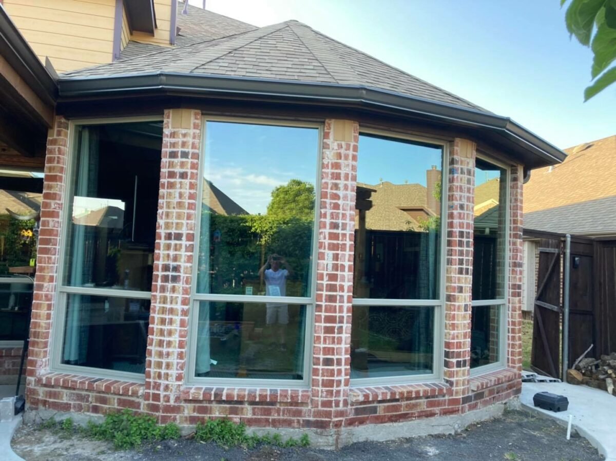 Replacement windows installed on a house exterior