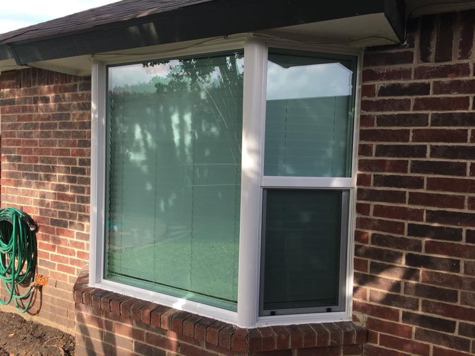Crew installing new windows on a residential house exterior