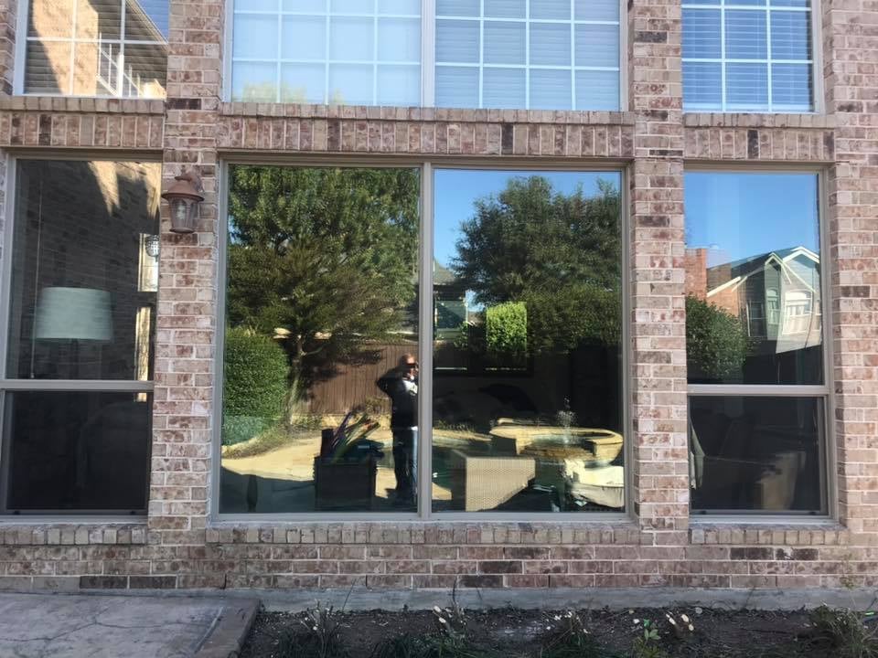 Close-up of a white double-hung replacement window on a home