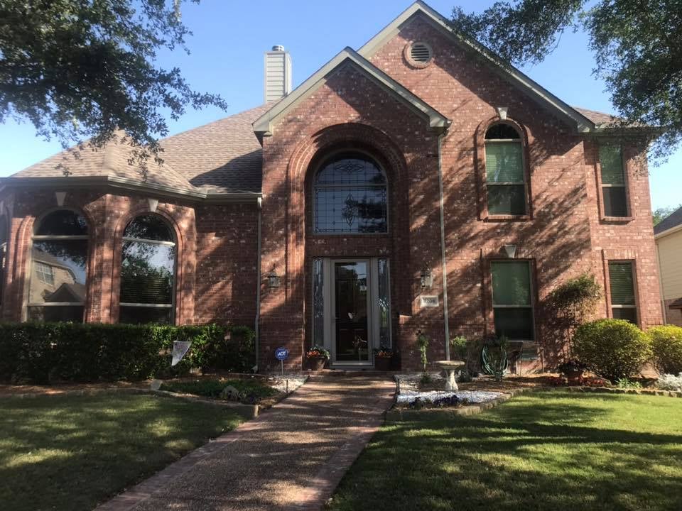 Row of white-framed replacement windows on a house